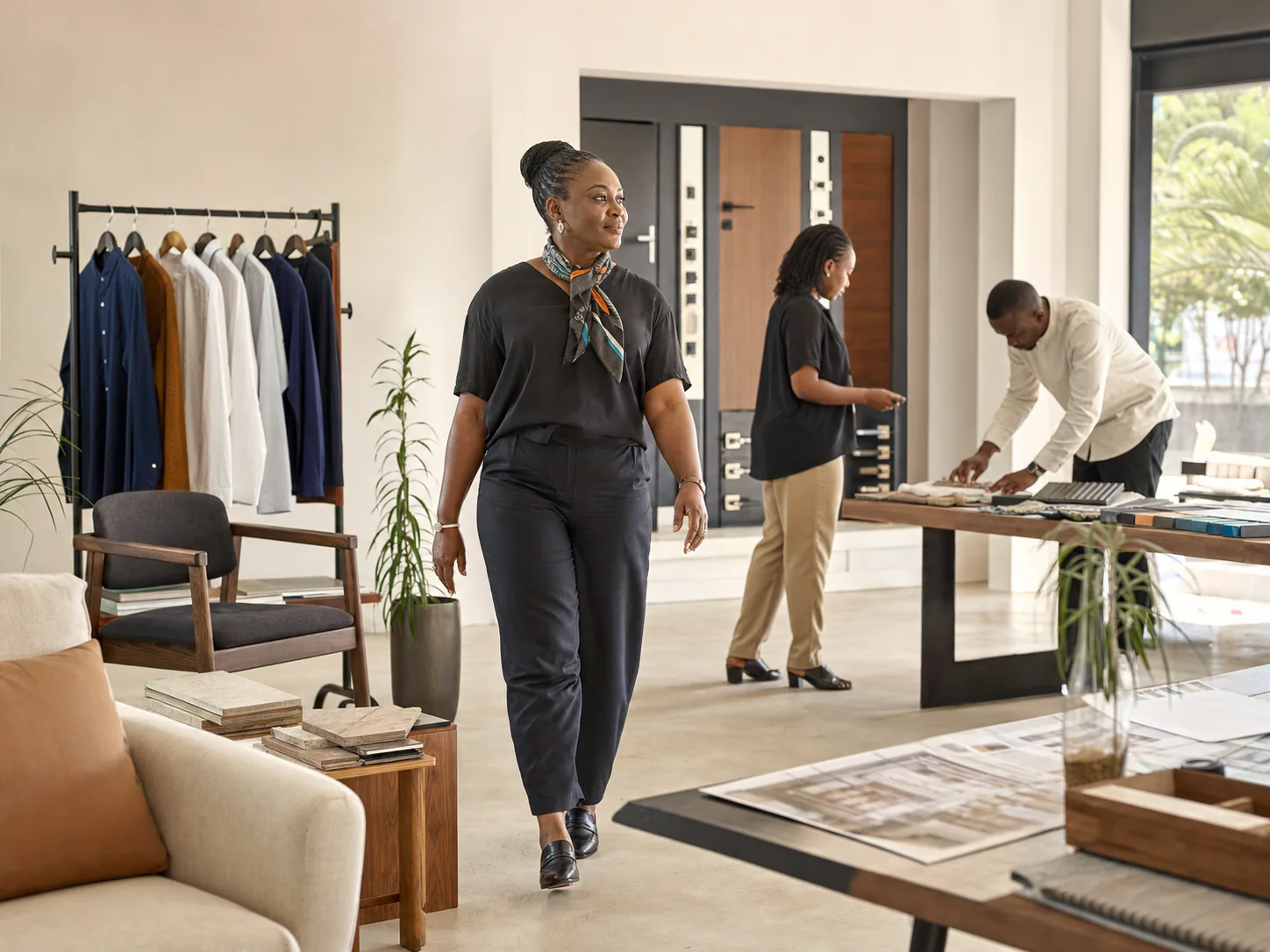 A Nigerian business owner walks through a showroom with fashion, door, furniture and property samples.